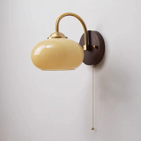Caramel oval sconce fading to red at the base on wood plate