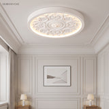Carved relief LED flush mount ceiling light in a styled interior