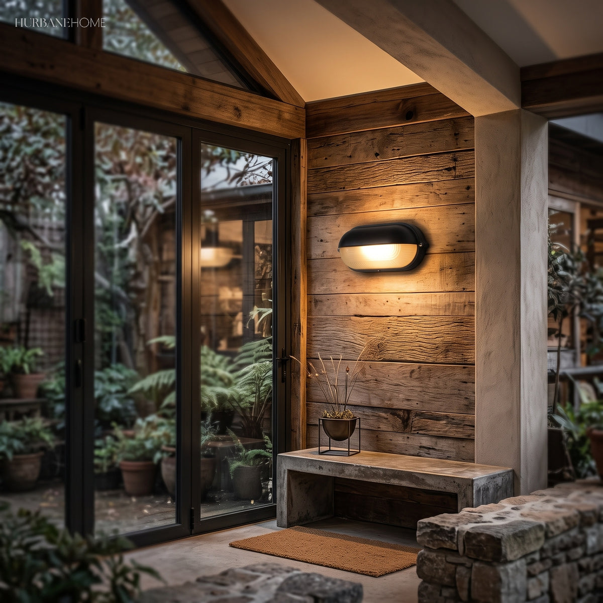 Dark bulkhead lamps lighting a timber lined entrance with potted ferns at night