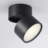 Black spot light photographed at an angle with the head folded forward
