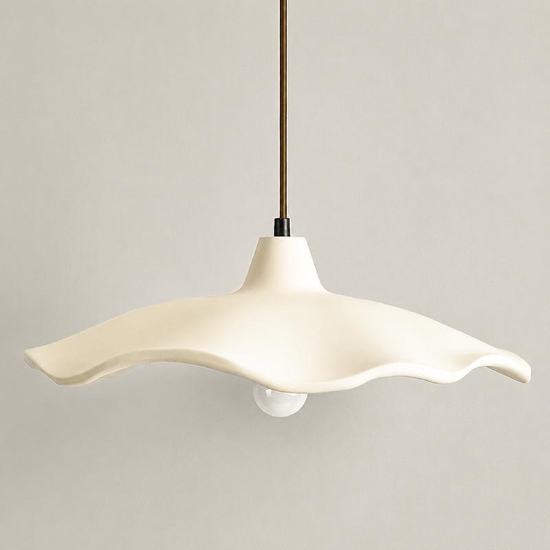 Two cement flower pendant lights near a vase of bare branches