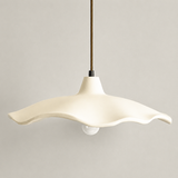 Two cement flower pendant lights near a vase of bare branches