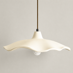 Two cement flower pendant lights near a vase of bare branches
