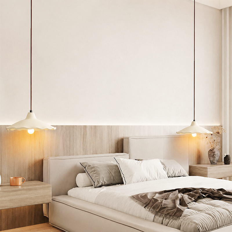 Four cement flower pendant lights in a row over a rustic stone-wall table