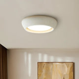 Angled close up of the cement flush mount showing its smooth curved rim