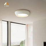Detailed view of the curved edge and recessed light of the ceiling fixture