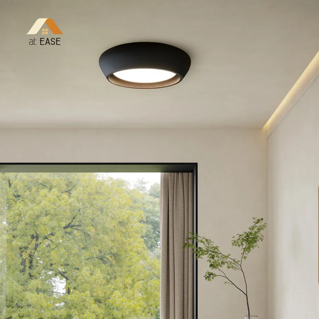 Close up of the textured cement surface on the rounded ceiling light body