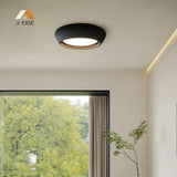 Close up of the textured cement surface on the rounded ceiling light body