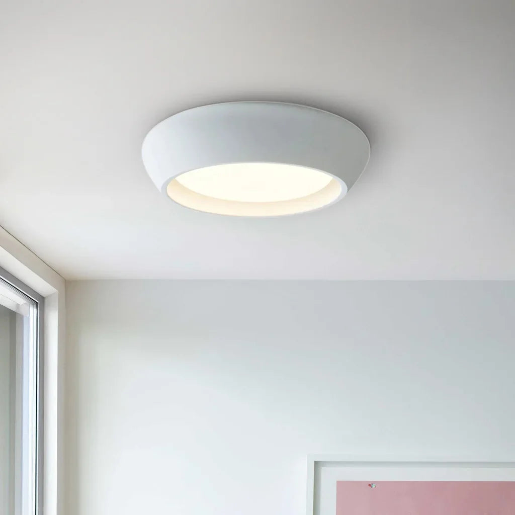 Bright white round flush mount ceiling light isolated on a clean white background
