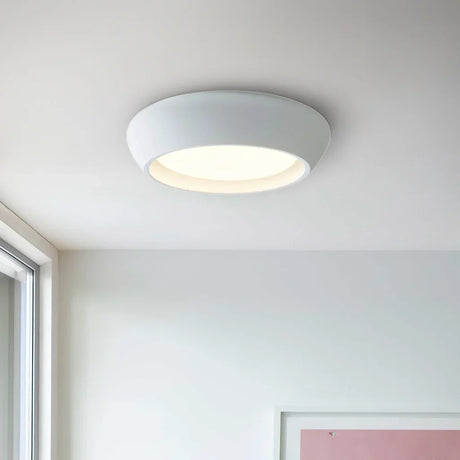 Bright white round flush mount ceiling light isolated on a clean white background