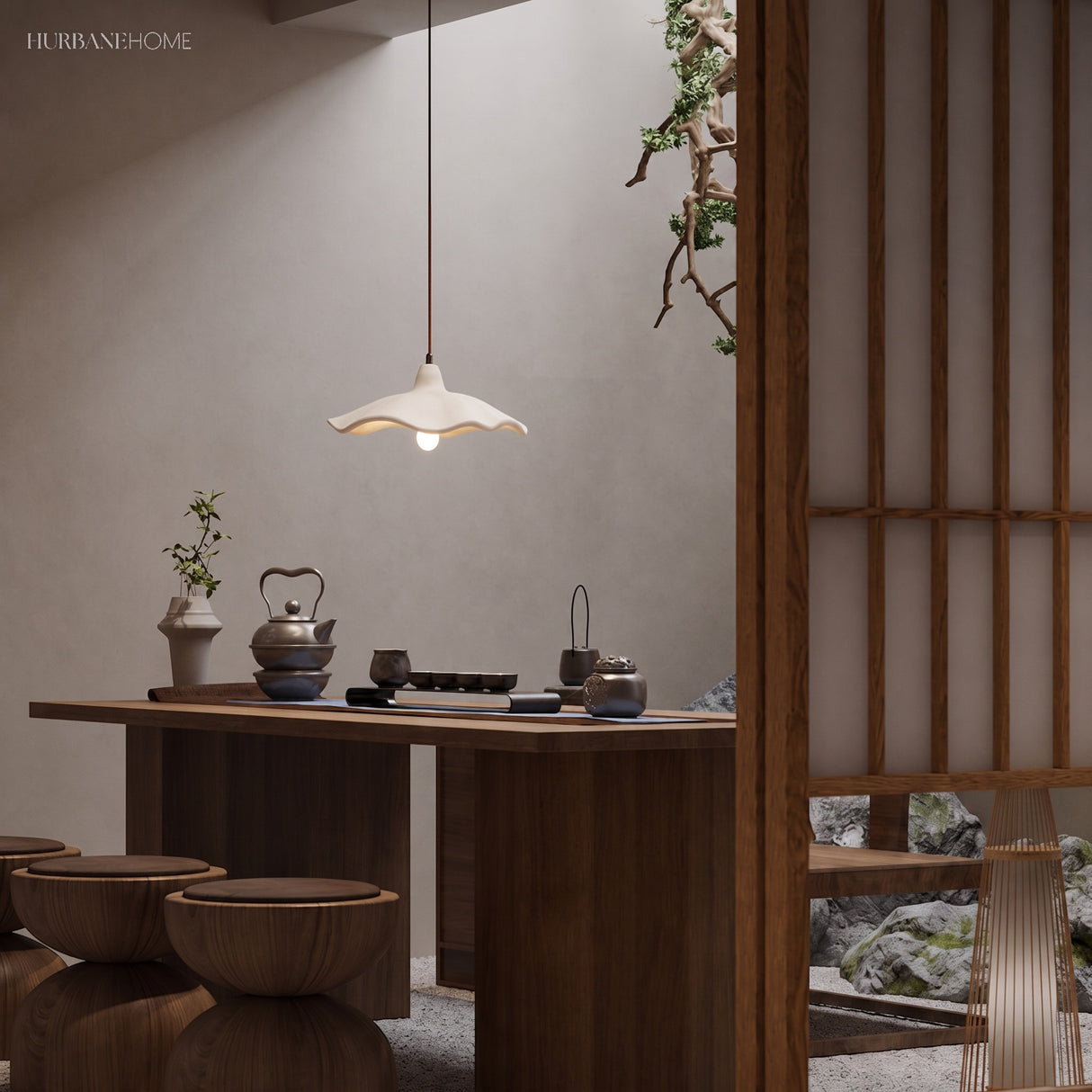 Cement flower pendant light over a walnut tea table in a Japanese room
