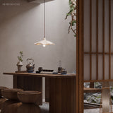 Cement flower pendant light over a walnut tea table in a Japanese room