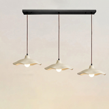 Three-light linear cement pendant fixture on one black ceiling plate