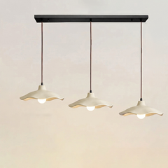 Three-light linear cement pendant fixture on one black ceiling plate
