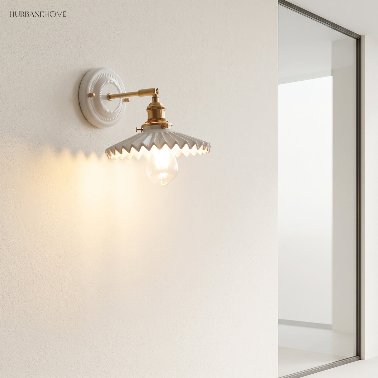 Ceramic and brass wall sconce in a styled interior