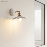 Ceramic and brass wall sconce in a styled interior
