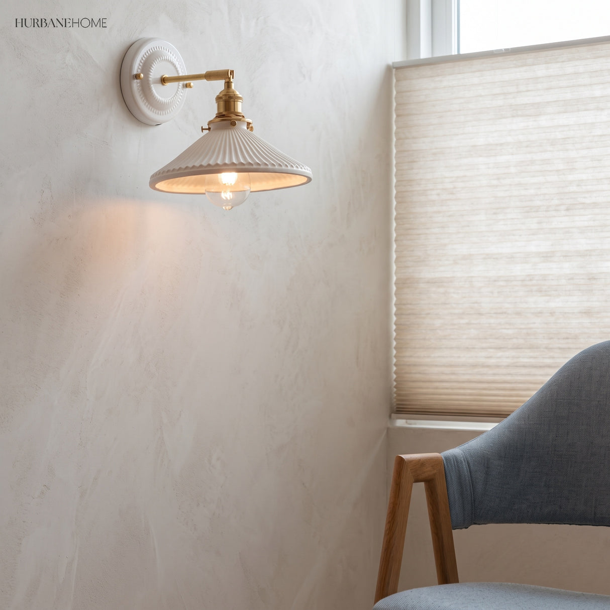 Ceramic and brass wall sconce in a styled interior