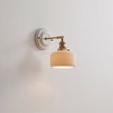 Ceramic shade and brass arm wall sconce, product photo