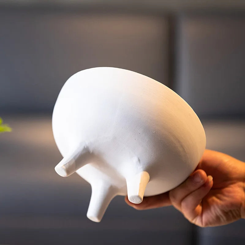 Ceramic footed fruit bowl styled on kitchen countertop with modern decor