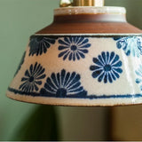 Close view of the painted shade meeting the brass socket collar