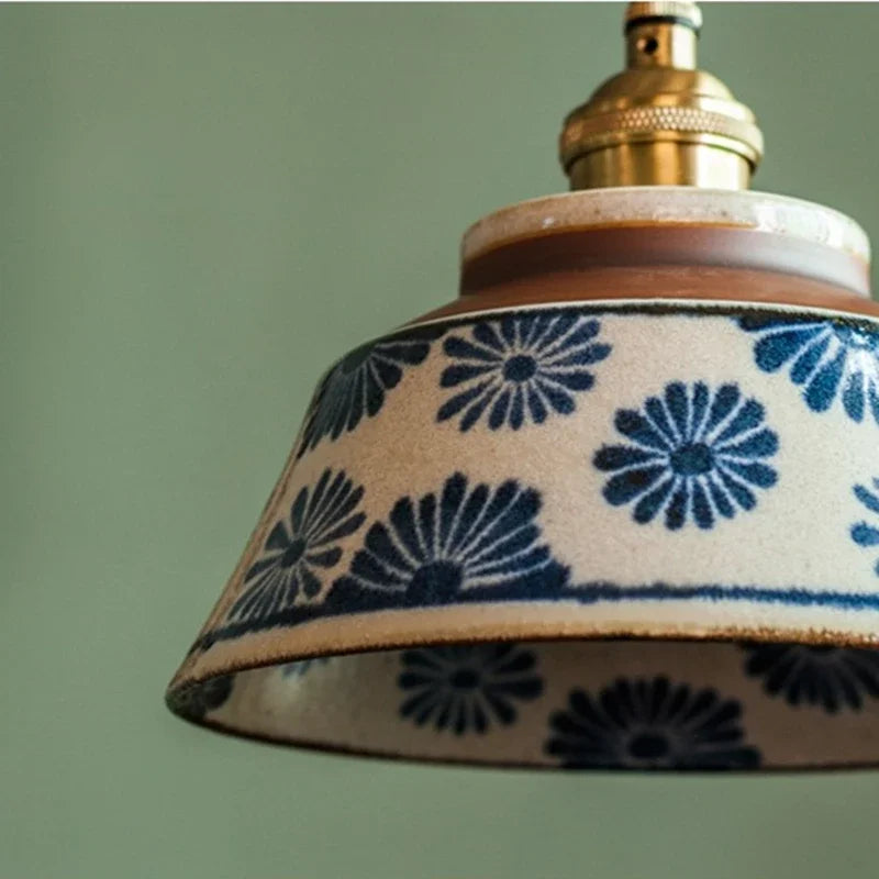 Close view of the hand painted blue daisy pattern on the glaze