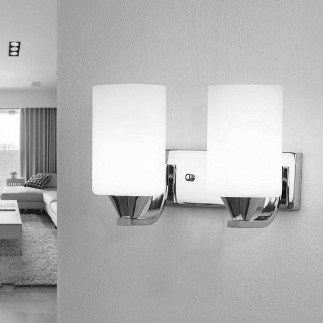 Two light chrome sconce mounted on a grey wall beside a bedroom
