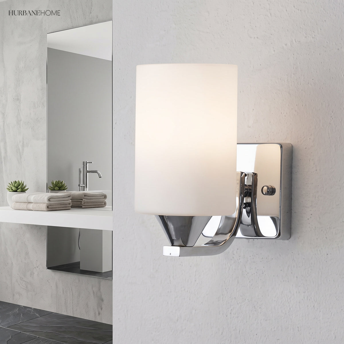 Single chrome vanity light above a bathroom basin with a framed mirror