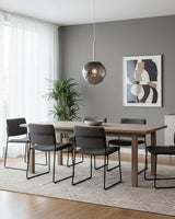 Chrome molten pendant hanging over a grey dining room table and six chairs