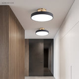 Two circular ceiling lights along a timber lined hallway