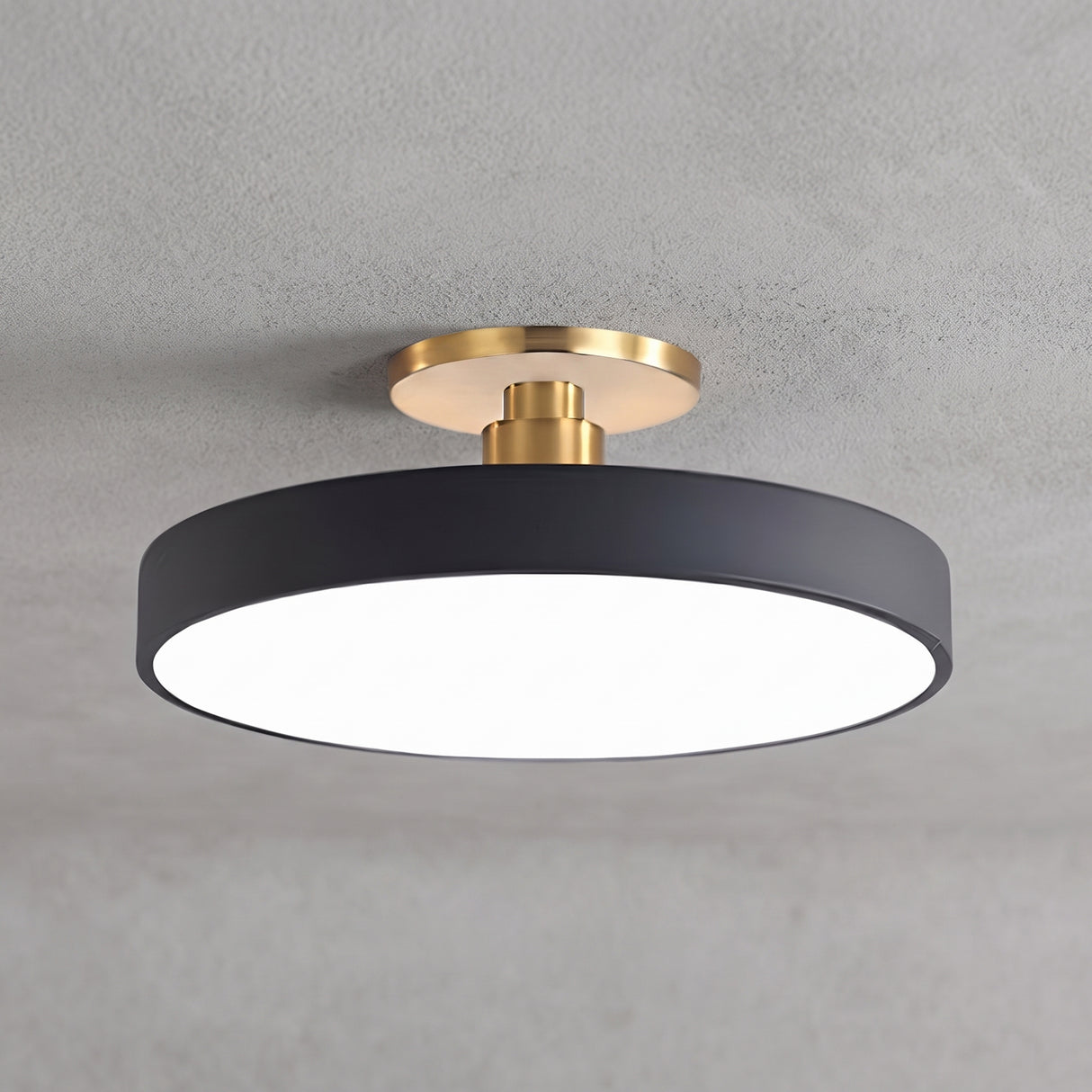 Circular LED semi flush ceiling light in black with brass mount