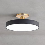 Circular LED semi flush ceiling light in black with brass mount