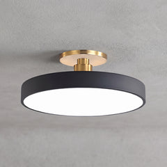 Circular LED semi flush ceiling light in black with brass mount