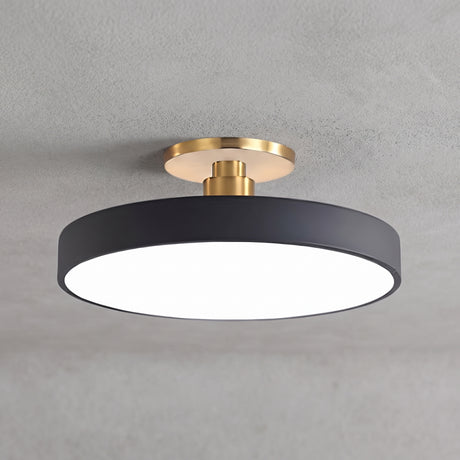 Circular LED semi flush ceiling light in black with brass mount