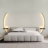 Minimalist wall light glowing softly in a clean grey bedroom
