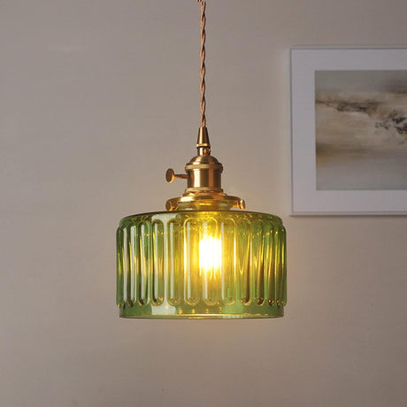 Fluted glass cylinder pendant shade on a brass holder and twisted cord