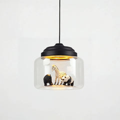 Clear glass drum pendant with black stepped cap holding zebra, bear and panda figures inside