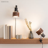 Clip-on spotlight reading lamp on a styled shelf