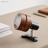 Clip-on spotlight reading lamp clamped to a desk