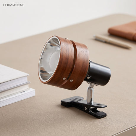 Clip-on spotlight reading lamp clamped to a desk