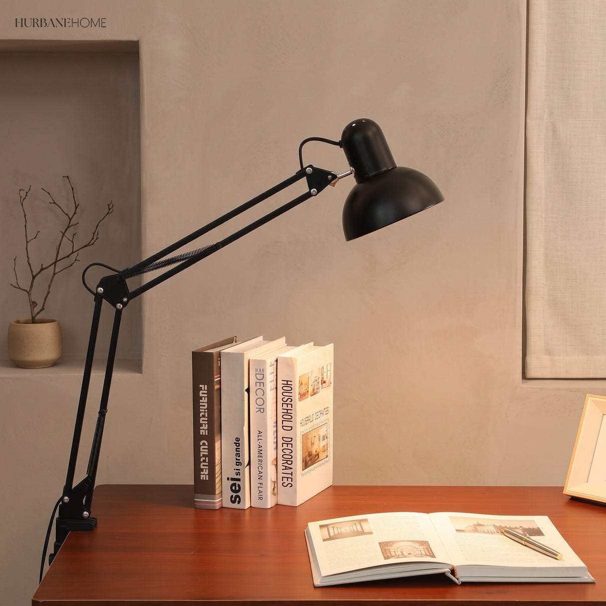 Clip-on reading lamp clamped to a desk edge with the arm extended