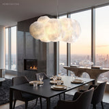 Cloud pendant light above a dining table in a modern high-rise