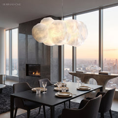 Cloud pendant light above a dining table in a modern high-rise