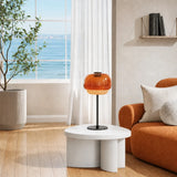 Close view of the amber glass dome shade and metal collar on the lamp