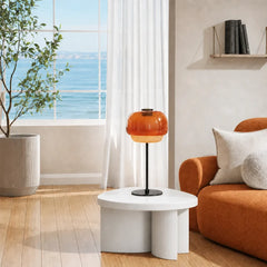 Close view of the amber glass dome shade and metal collar on the lamp