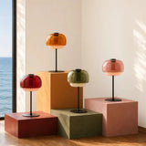 Lit amber glass table lamp showing warm glow through the domed shade