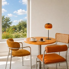 Side profile of the amber glass table lamp on a plain background