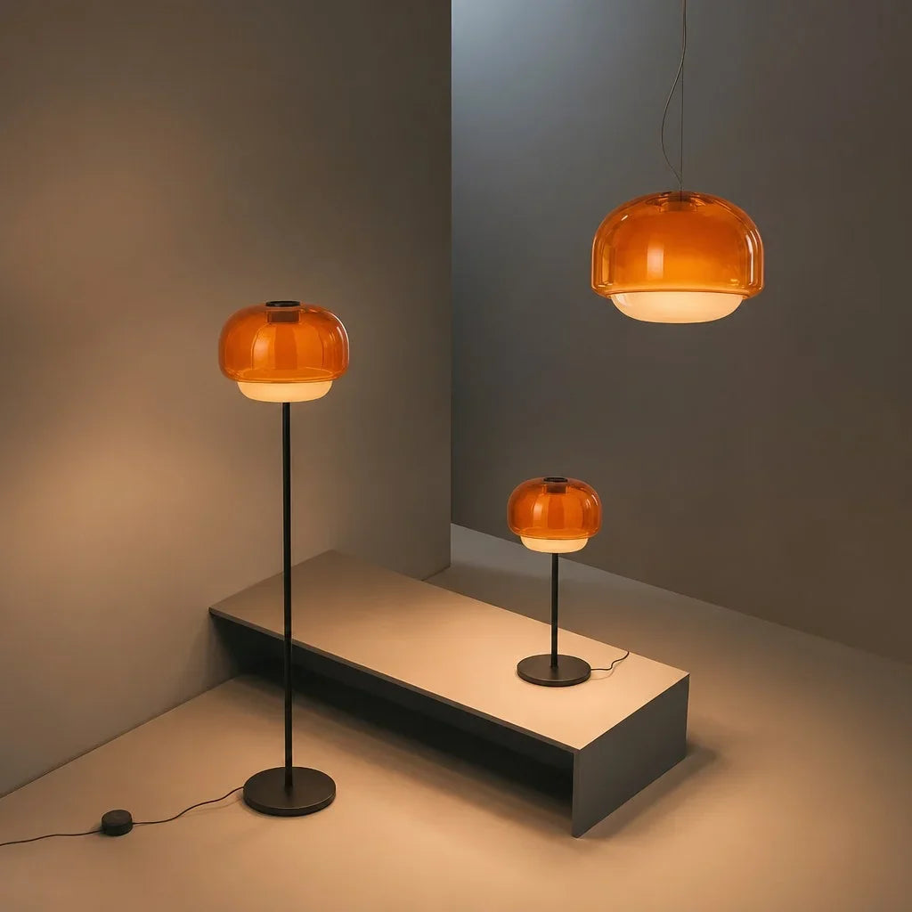Rounded colored glass shade glowing softly above a slim metal lamp stem
