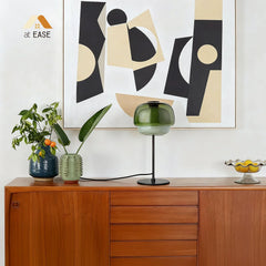 Domed glass table lamp in a warm tone with slim metal support