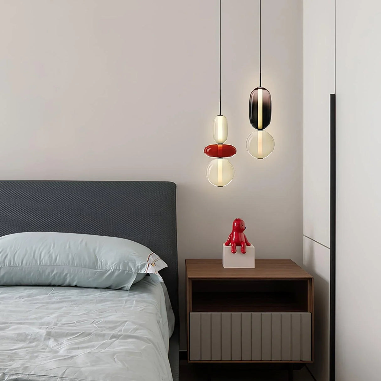 Modern pendant light showing black and smoke glass jar shapes