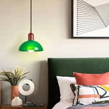Colorful glass pendant light hung at height to show its dome shape